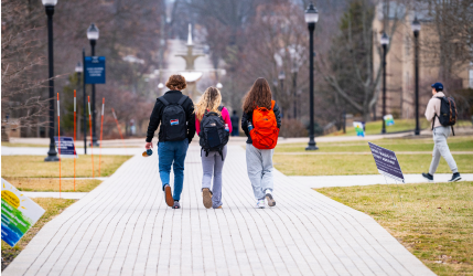 Students walking down a path in fall